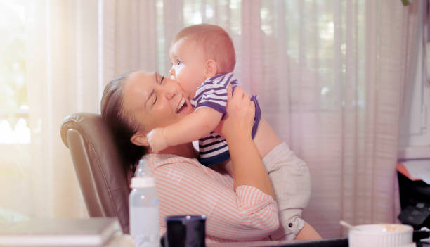 istock Young mother playing with baby boy at office 1199993611