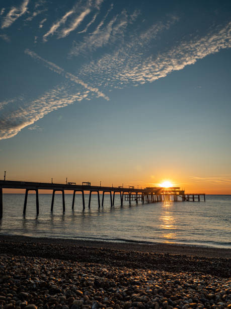 istock Cloudy sunrise over the pier 1199998004