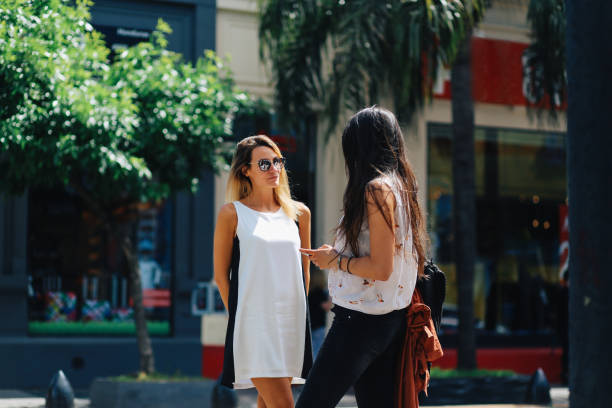 istock Two women talking in the park 1199998161