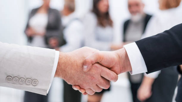 istock close up. business handshake on office background. 1199999136