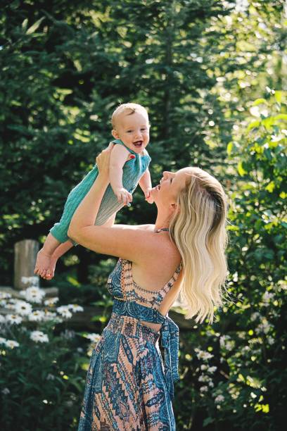 Mother Playing Baby Boy Outdoors A beautiful mom plays her baby boy outside on a sunny day.
baby is seven months old. baby boy dancing with his mommy stock pictures, royalty-free photos & images