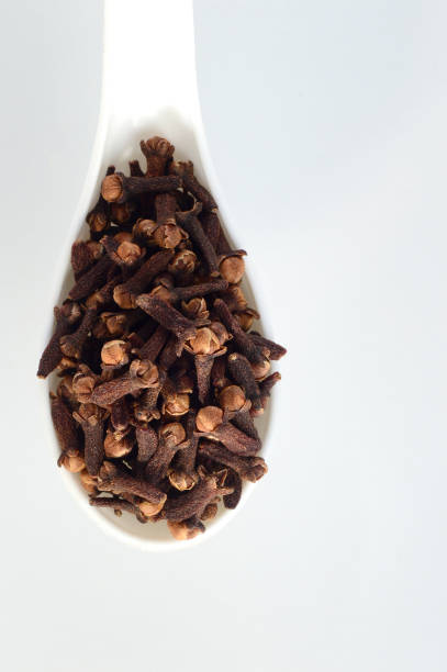 istock clove in spoon isolated on a white background 1200006542
