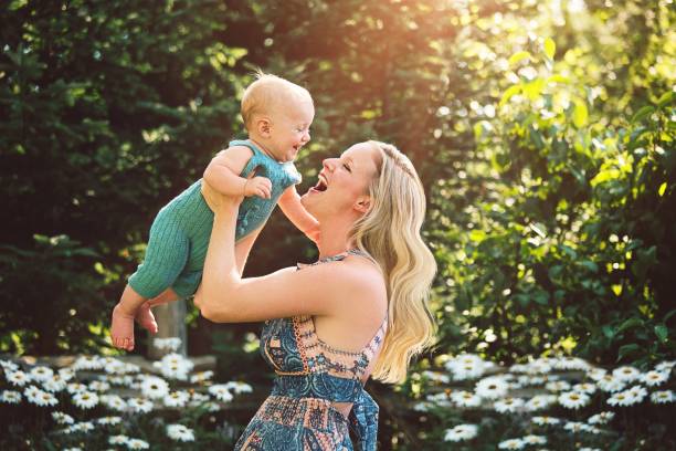 Mother Playing With Baby Boy Outdoors A beautiful mom plays her baby boy outside on a sunny day.
Baby is seven months old. baby boy dancing with his mommy stock pictures, royalty-free photos & images