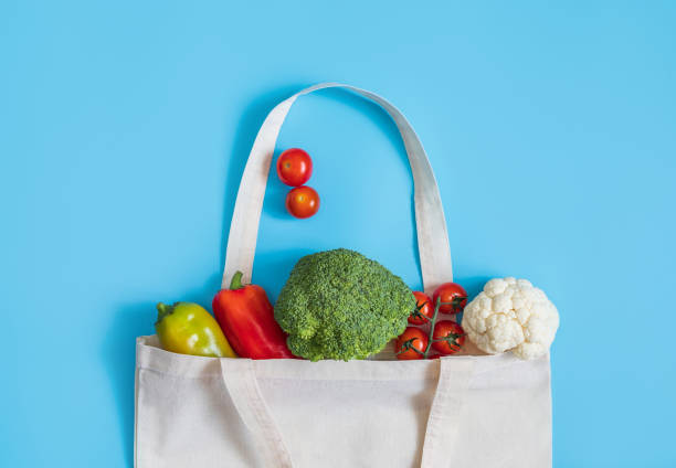 istock Zero waste concept. Vegetables in eco friendly reusable textile bag on blue background. Plastic free. Healthy fresh vegetarian food. 1200008467