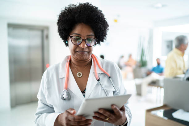 istock Mature female doctor using digital tablet at medical office 1200010053