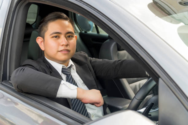 istock Young asian man wearing suit driving car 1200013462