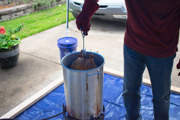 Deep Frying Turkey for Thanksgiving Outside At Home Deep Frying Turkey for Thanksgiving Outside At Home deep fryer stock pictures, royalty-free photos & images