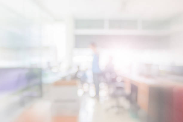 istock Businessman blur in the workplace at sitting on a computer screen work space on table desk work in office blurry, document division and people shallow depth of focus horizontal abstract interior. 1200017656