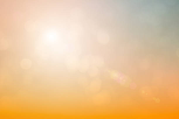 istock Natural background blurring warm colors and bright sun light. Bokeh or Christmas background Green Energy at sky sunny color orange light patterns plain abstract flare evening clouds blur. 1200017658