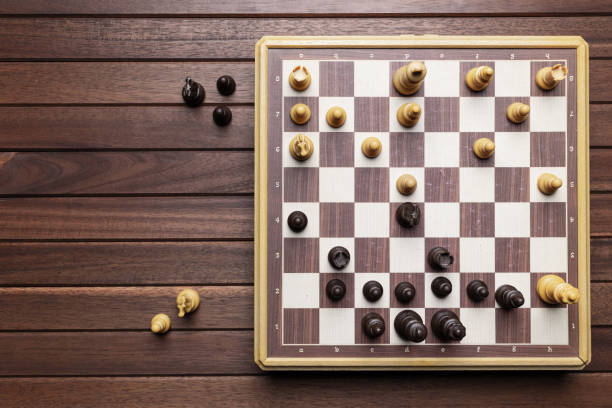 istock Chessboard on wooden background 1200017854