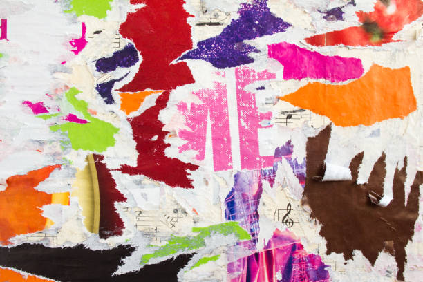 istock Torn and peeling pieces of old shabby gloss paper placards texture background. 1200019059