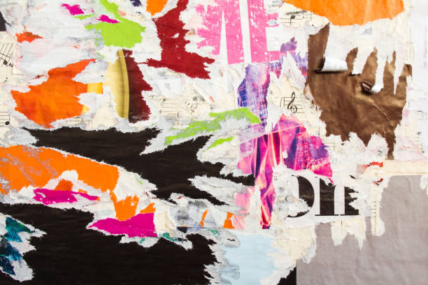 istock Torn and peeling old shabby gloss paper placards and posters layers on rough surface texture background. 1200019064