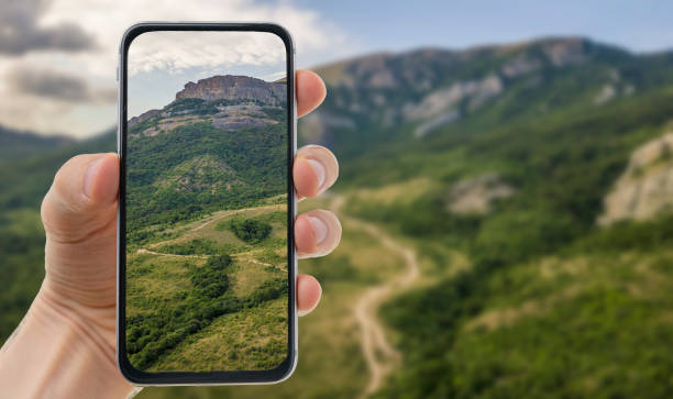 istock hand holding a  mobile smartphone and taking a landscape photography 1200021243
