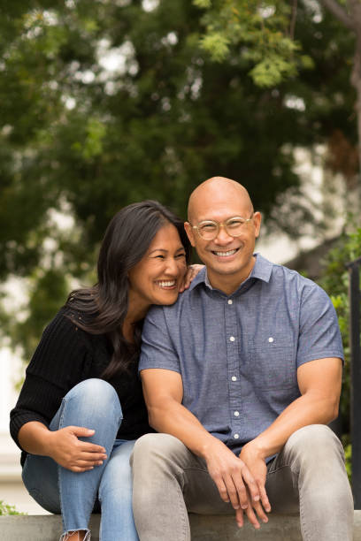 istock Happy Asian couple smiling and hugging outside. 1200021594