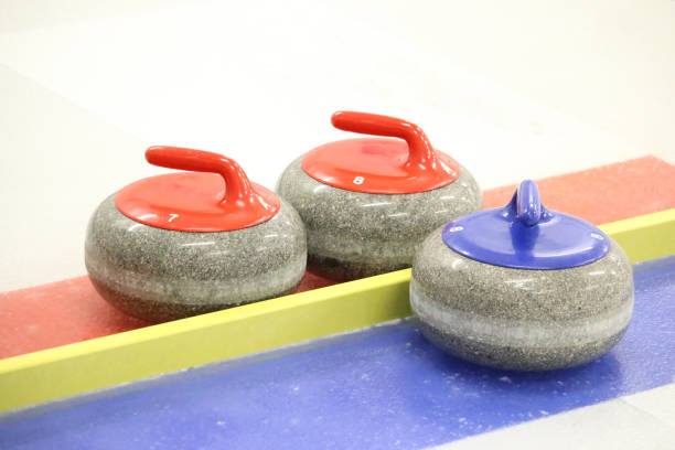 istock Three curling stones on the ice 1200022598