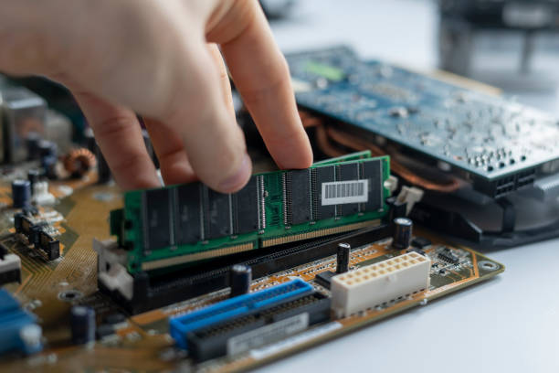 close up hand insert or install the ram memory component in the pc motherboard stock photo