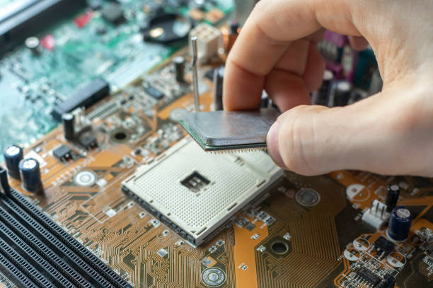 istock the scientist hand install the cpu processor in the motherboard socket and doing the research in laboratory 1200023282