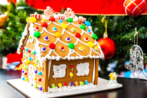 istock Gingerbread house in front of Christmas Tree 1200028589