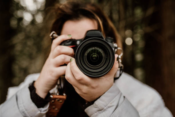 istock Woman taking a picture with a DSLR camera 1200028616