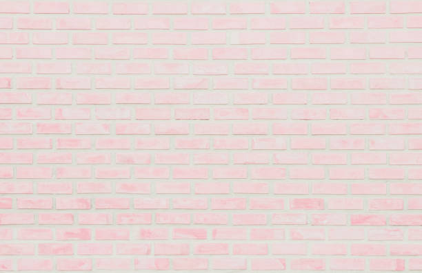 istock Pastel Pink and White brick wall texture background. Brickwork or stonework flooring interior rock old pattern clean concrete grid uneven brick design stack. Home or office design backdrop decoration. 1200031698