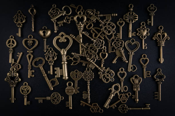 istock Bronze keys on black background antique key still life 1200035438