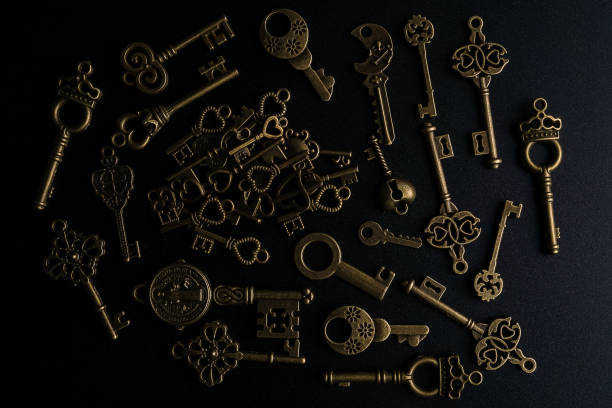 istock Bronze keys on black background antique key still life 1200035987
