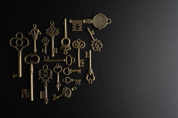 istock Bronze keys on black background antique key still life 1200036100