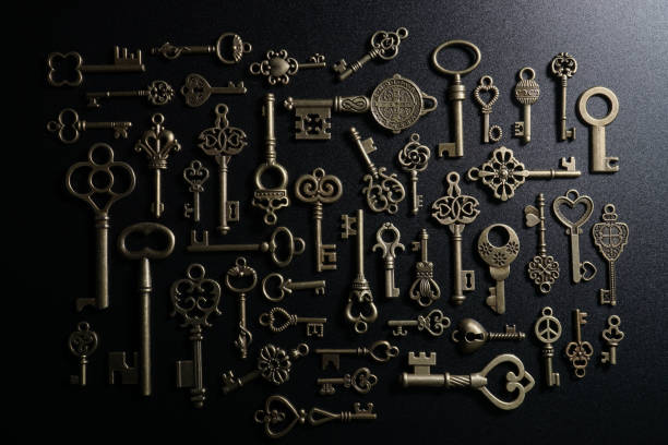 istock Bronze keys on black background antique key still life 1200036194
