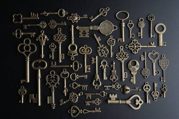 istock Bronze keys on black background antique key still life 1200036335
