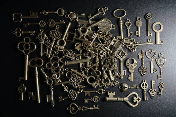 istock Bronze keys on black background antique key still life 1200036397