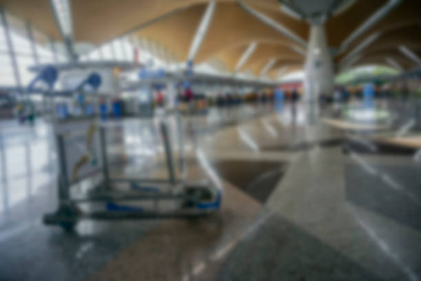 istock People at airport terminal blur background with bokeh light. 1200043360