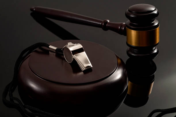 Whistleblower protection law and freedom of information legislation conceptual idea with metal whistle and wooden judge gavel on dark background Whistleblower protection law and freedom of information legislation conceptual idea with metal whistle and wooden judge gavel on dark background supreme court justice photos stock pictures, royalty-free photos & images