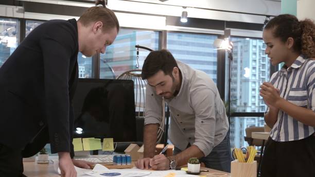 istock Creative business people group having conversation at office desk in workplace. 1200045685