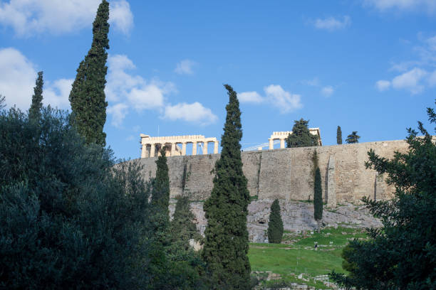 istock Athens, Greece, Acropolis hill.  Parthenon, trees and ancient walls under blue sky with clouds. 1200045848