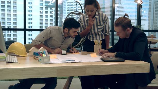 istock Creative business people group having conversation at office desk in workplace. 1200045876