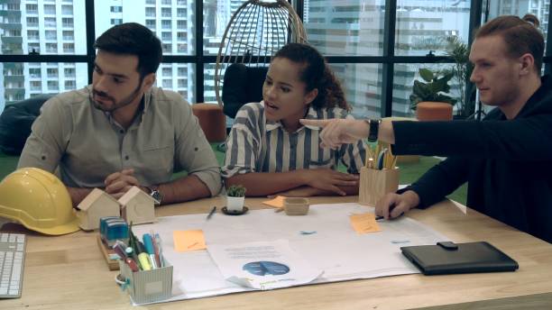 istock Creative business people group having conversation at office desk in workplace. 1200045879