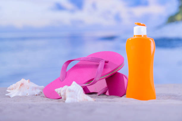 istock Flip flops surrounded by seashells and sunscreen bottle 1200046655