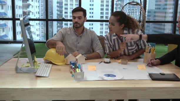 istock Creative business people group having conversation at office desk in workplace. 1200046743
