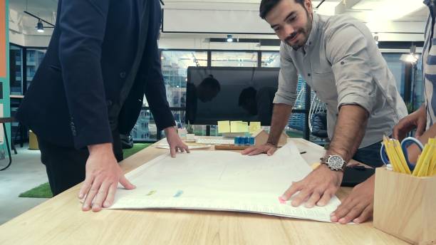 istock Creative business people group having conversation at office desk in workplace. 1200046751