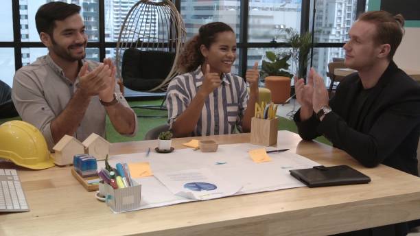istock Creative business people group having conversation at office desk in workplace. 1200046764