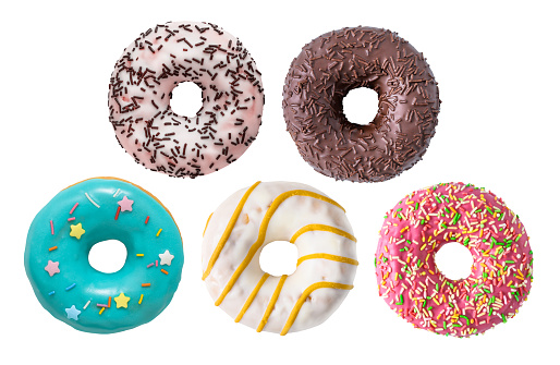 Mix of multicolored doughnuts with sprinkle . Chocolate frosted , pink strawberry glazed with sprinkle, caramel and mint donuts isolated on white background close-up.