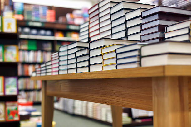 Books stacked on table at bookstore Stack of books on display at the bookstore bookstore stock pictures, royalty-free photos & images