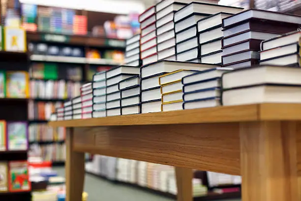 Photo of Books stacked on table at bookstore