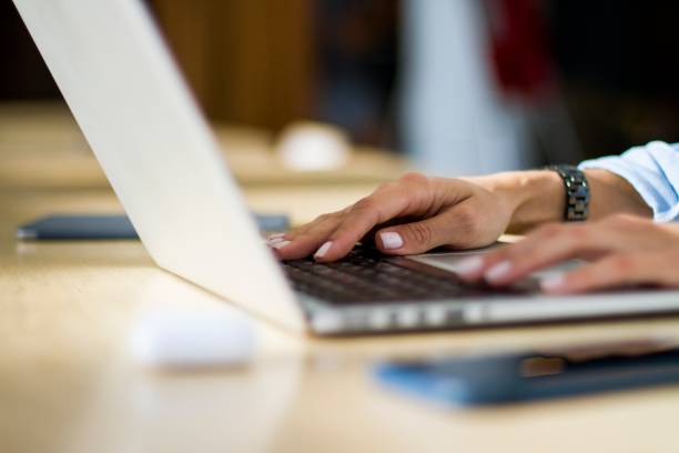 istock Woman hands typing on a laptop keyboard, close up 1200048624