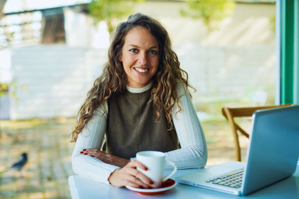 istock Attractive young curly brunette looking at camera 1200048645