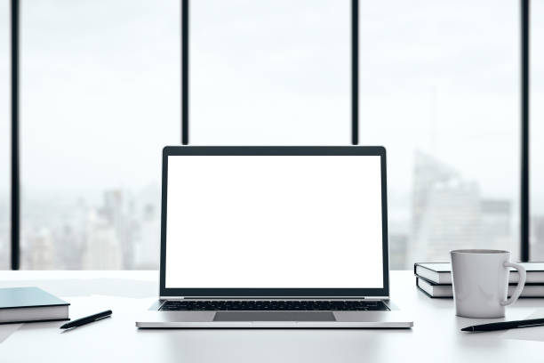 istock Laptop with blank white screen on a desktop on a big window background with city view, mockup. 3D Rendering 1200049067