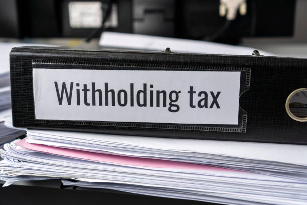 Pile of Taxation document files concept : Withholding tax, retention tax is income tax to paid to government by payer rather than by recipient, applies to employment income, recipient's tax liability concepto de expedientes de documentos de pile of ttax : retención de impuestos, el impuesto de retención es el impuesto sobre la renta pagado al gobierno por el pagador en lugar de por el beneficiario, se aplica a los ingresos del empleo, la responsabili