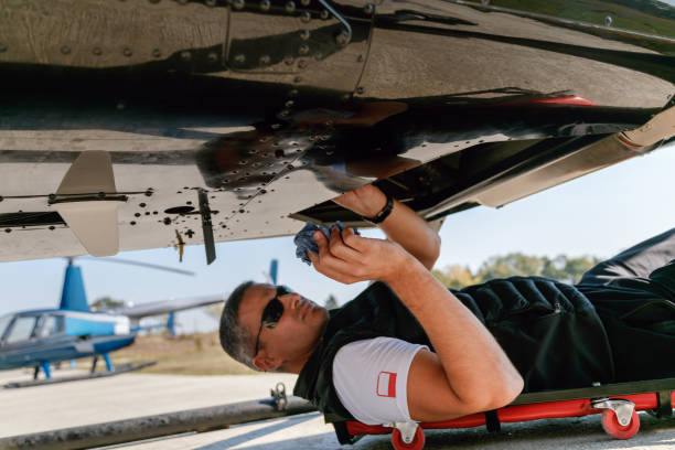 istock Maintenance engineer cleaning the engine under the helicopter 1200052228