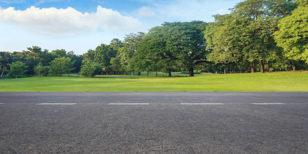 Empty highway asphalt road and beautiful sky in landscape green park stock photo