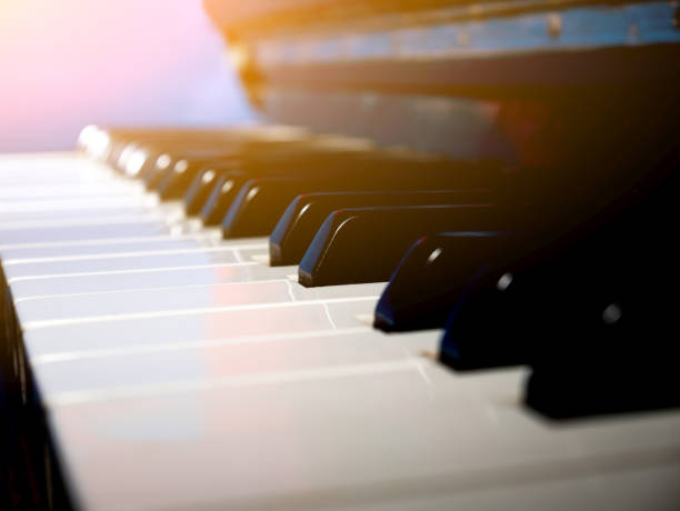 istock Old retro piano keys. close up view. Black and white keys, octave. Lighting effect 1200052480